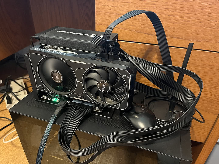 Photo of an M.2 eGPU setup sitting on top of a computer case