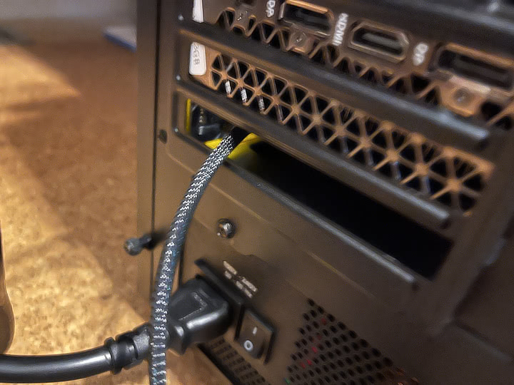 Photo of an oculink wire running out of the back of a computer case